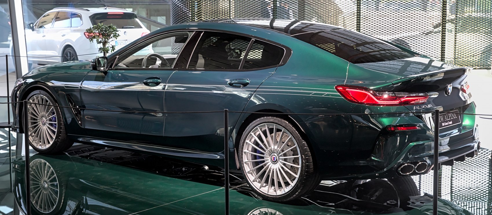Sleek side profile with multi-spoke wheels and coupe-style rear