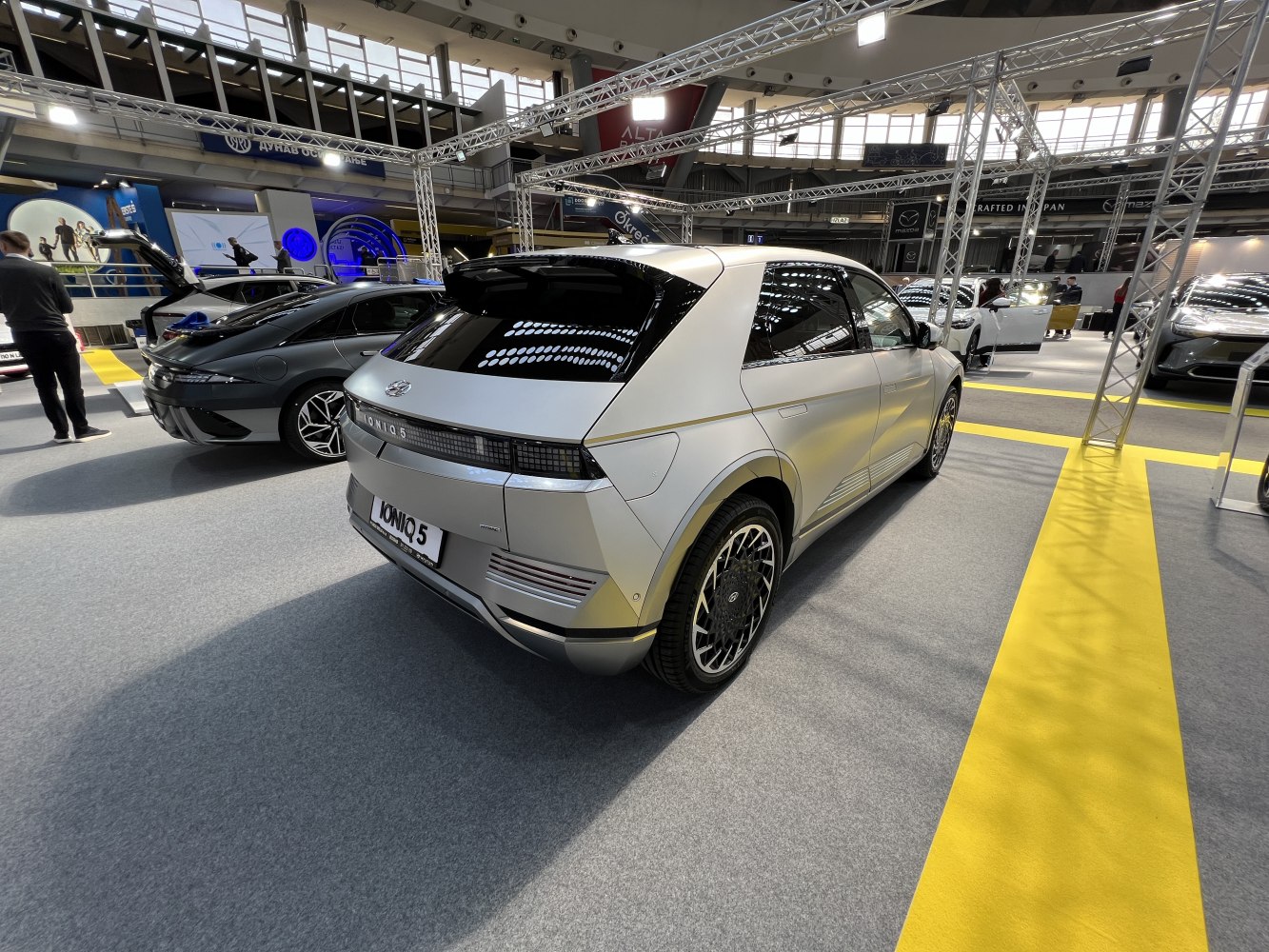 Rear and side profile with unique wheels and hatchback design.