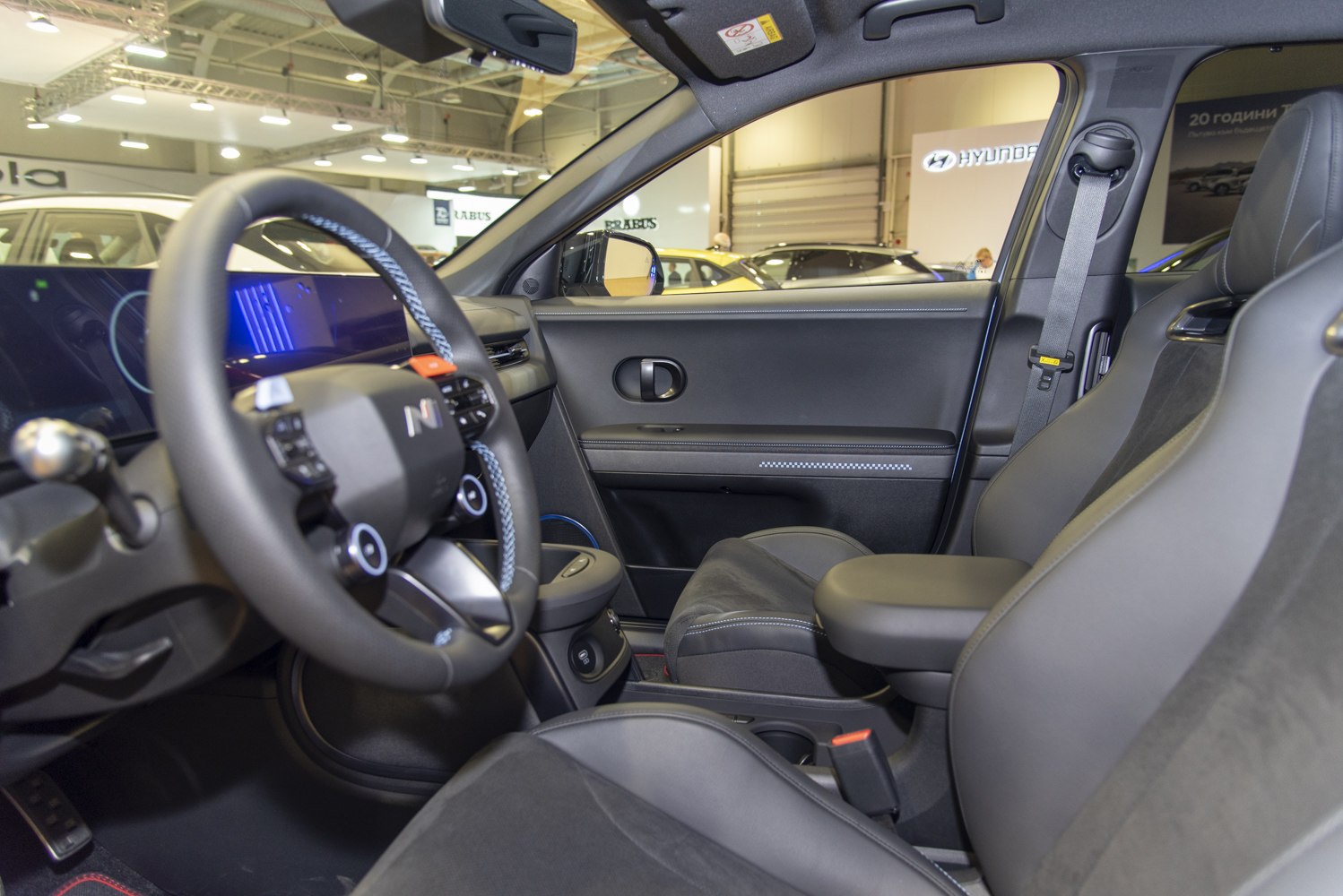 Electric vehicle interior with digital dashboard and multifunction steering wheel
