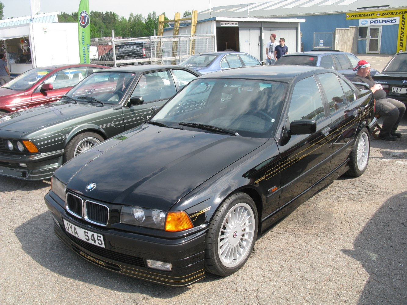 Vintage sedan with signature gold striping and detailed multi-spoke alloy wheels.