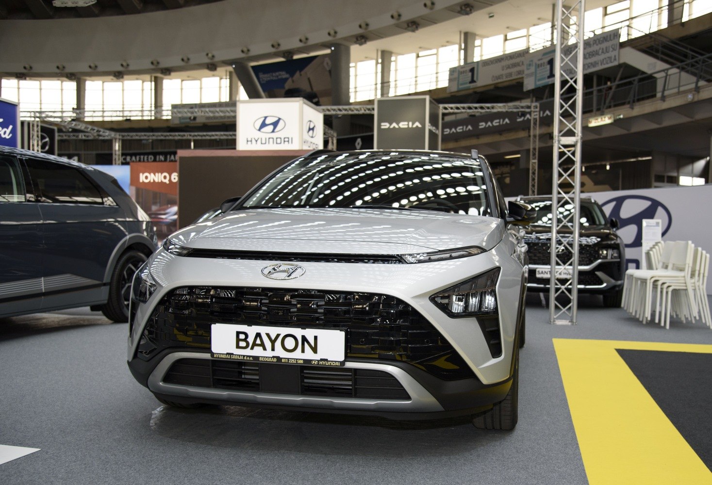 Front view of vehicle with split headlights and large grille