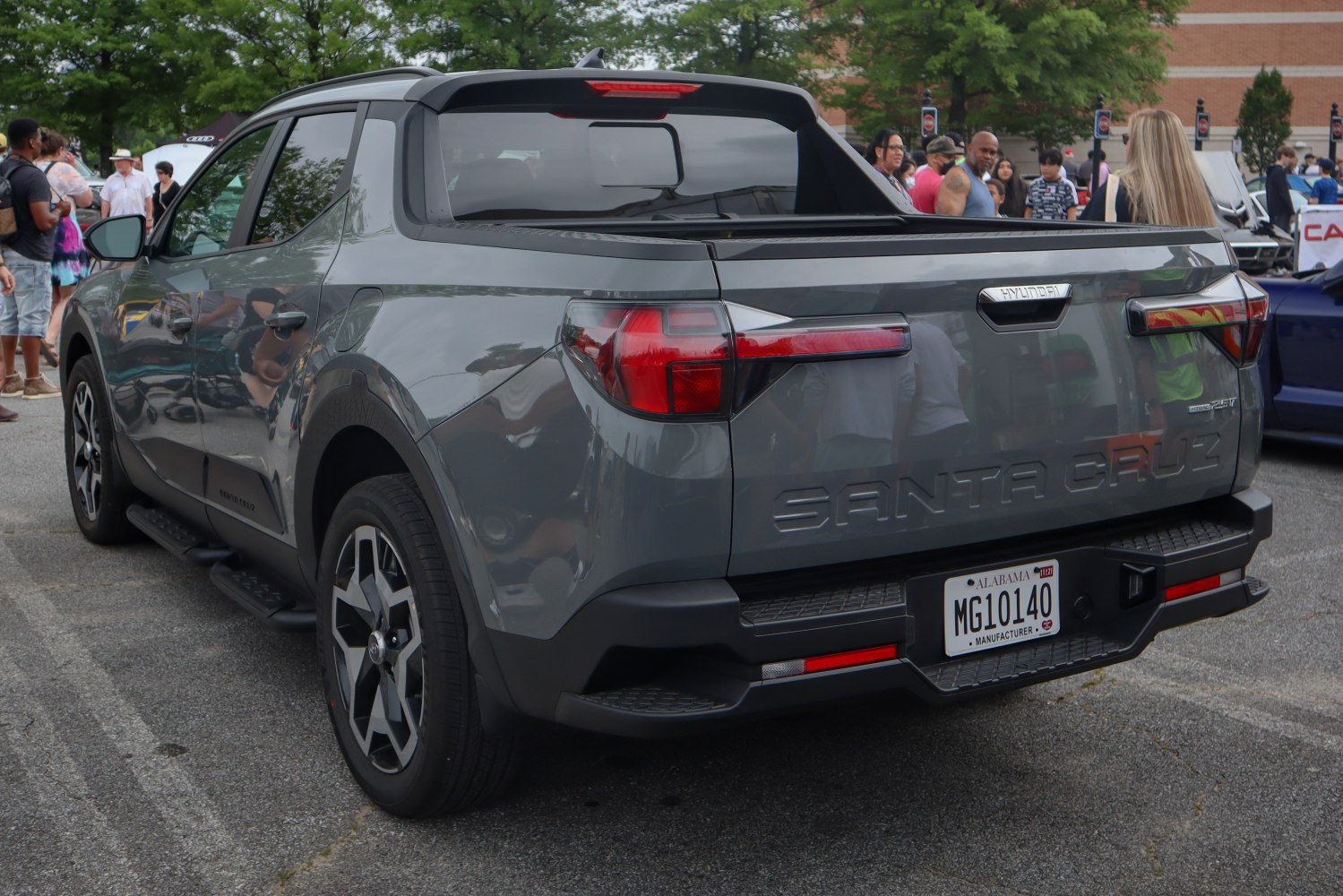 Rear view showing tailgate and distinctive taillights of a modern pickup.