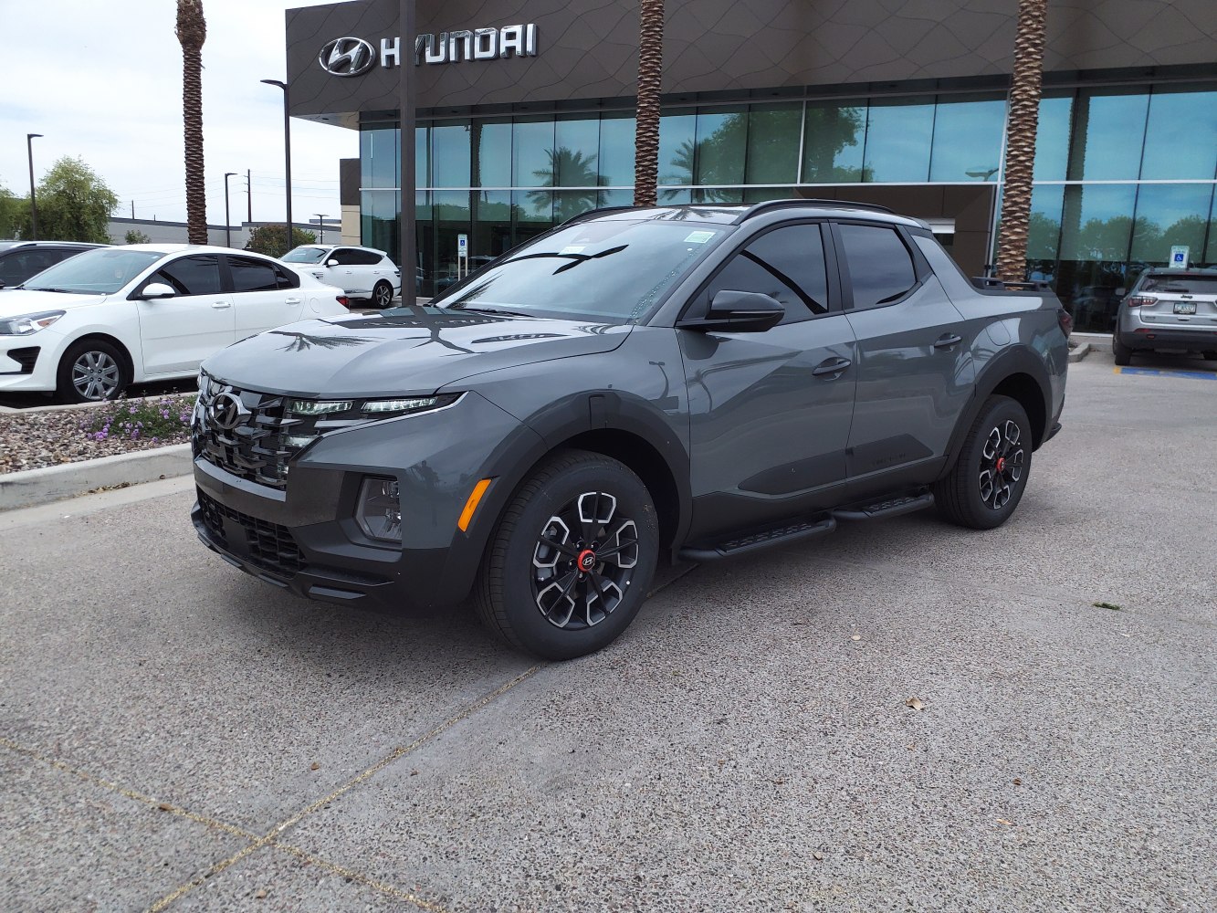 Front-side view of modern gray pickup truck with sporty grille and wheels