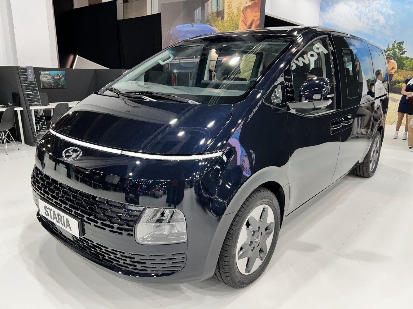 Sleek front view of a modern minivan with unique headlights and grille