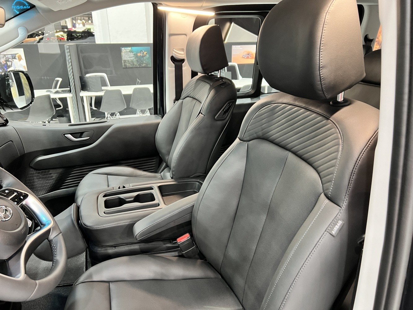 Leather front seats with armrest and detailed stitching.