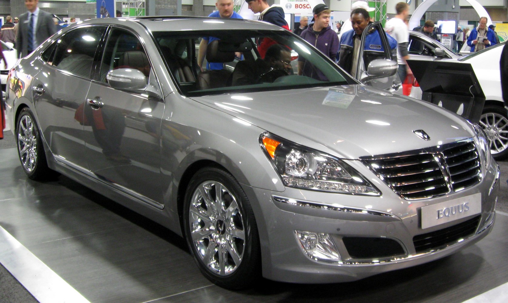 Luxury sedan front view with chrome grille and alloy wheels