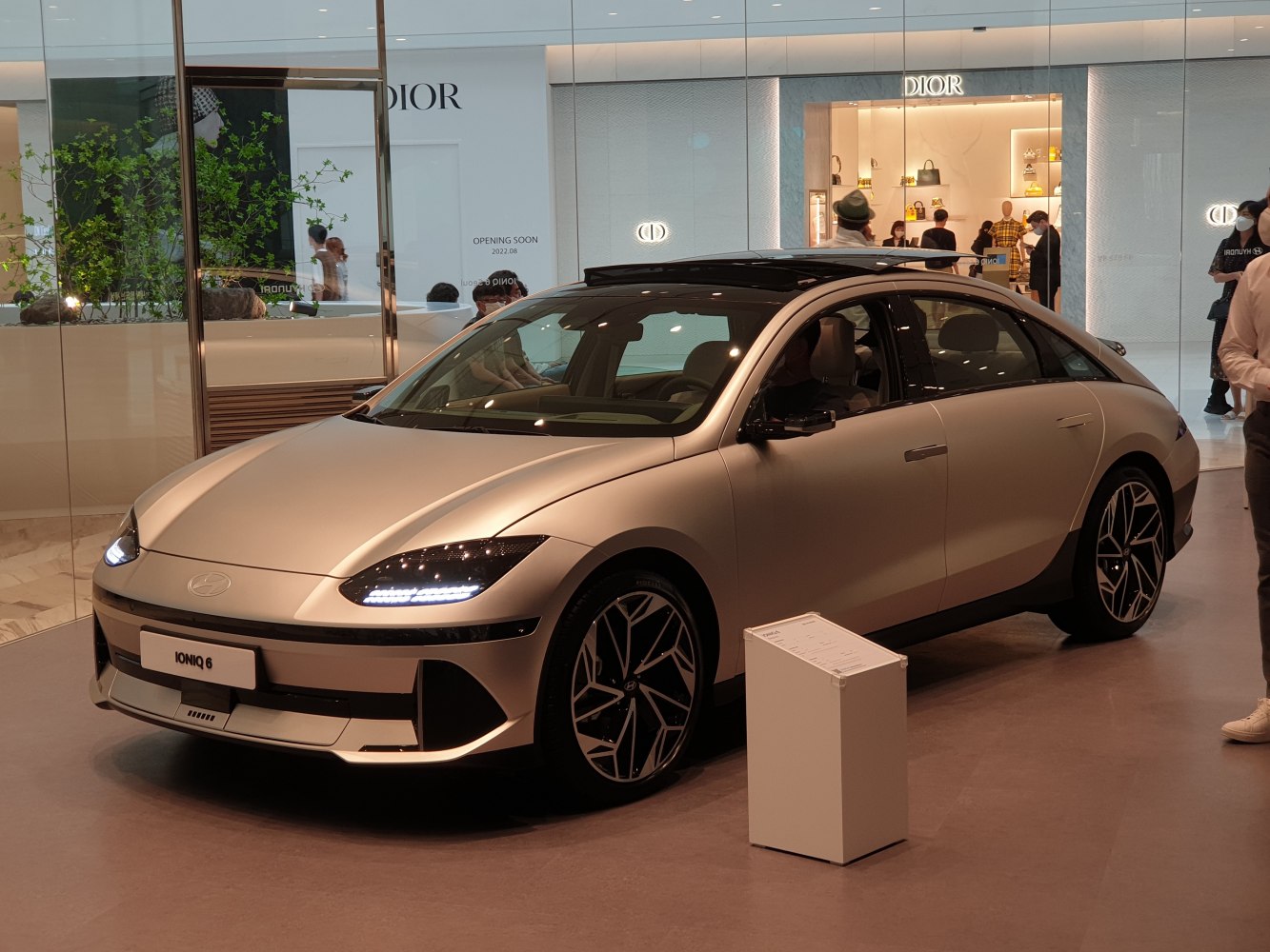 Futuristic electric sedan with distinctive LED headlights and sleek aerodynamic shape