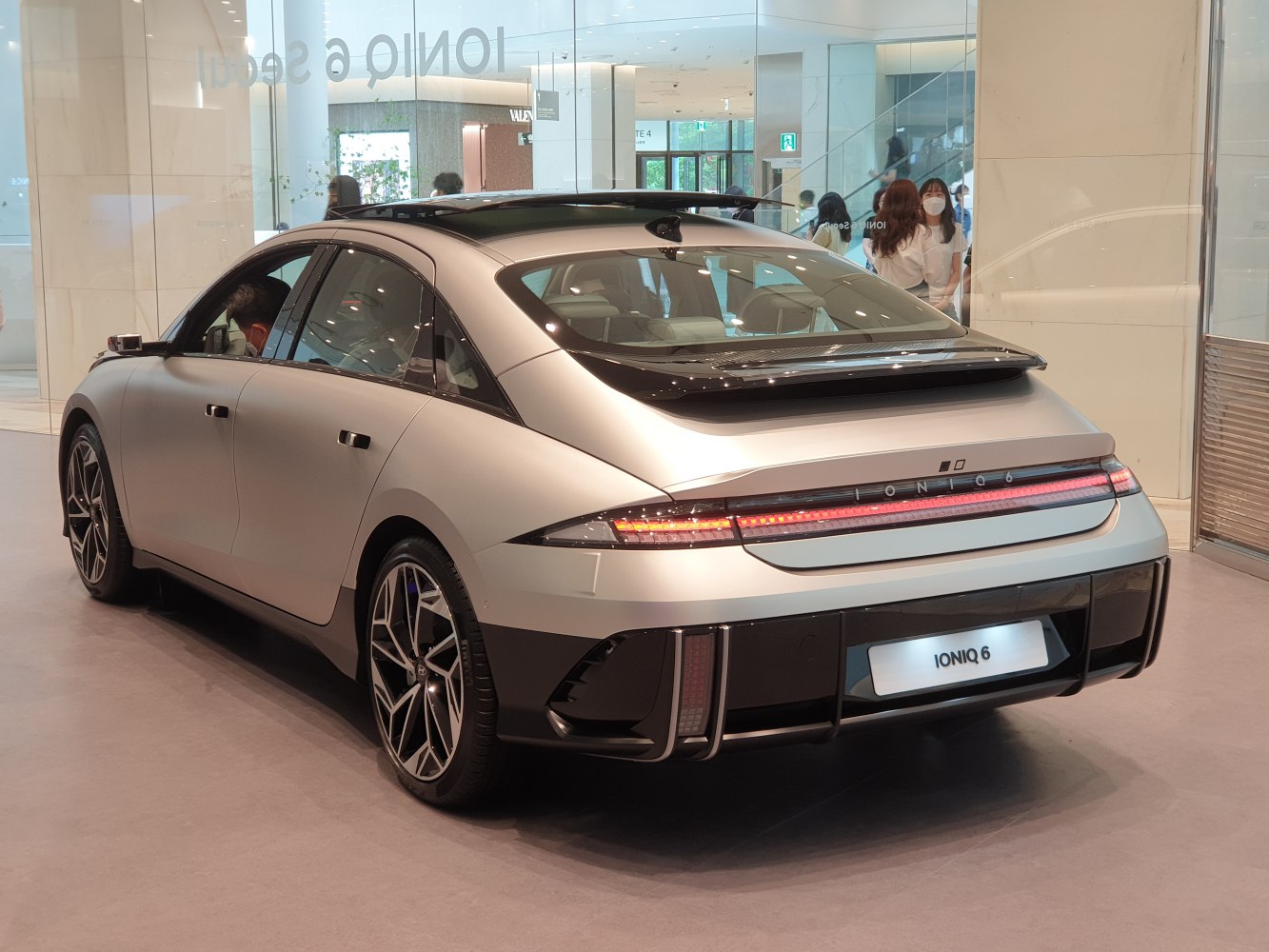 Rear view with sleek LED tail lights and aerodynamic hatchback design
