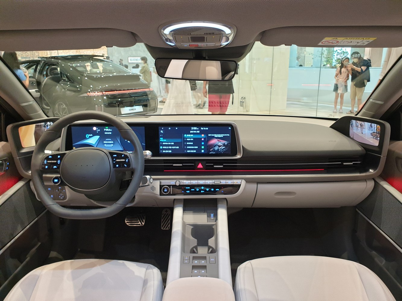 Modern electric car interior with dual digital displays and digital side mirrors