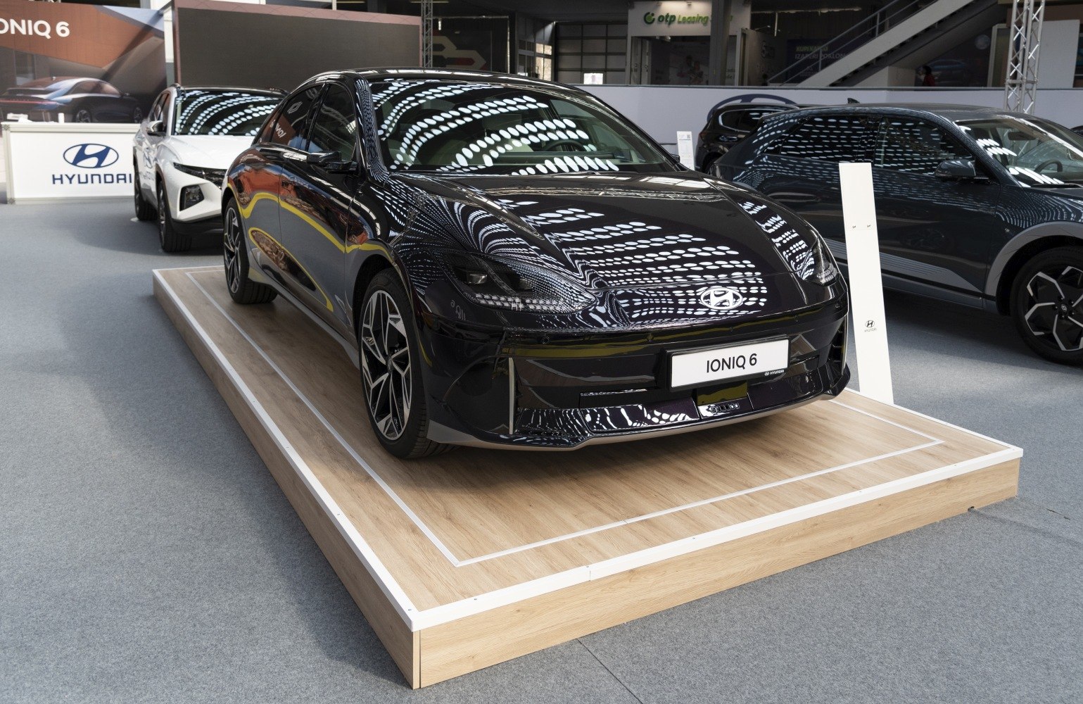 Sleek black electric sedan with aerodynamic design and modern LED headlights.
