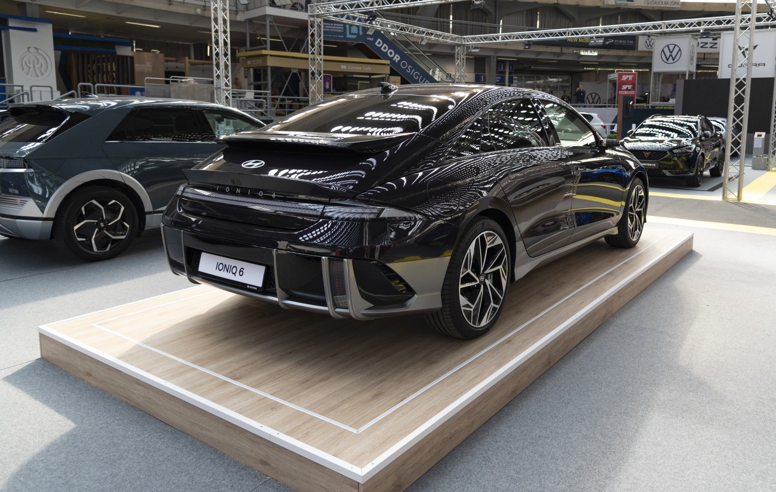 Rear view of electric sedan with LED taillights and sporty alloy wheels