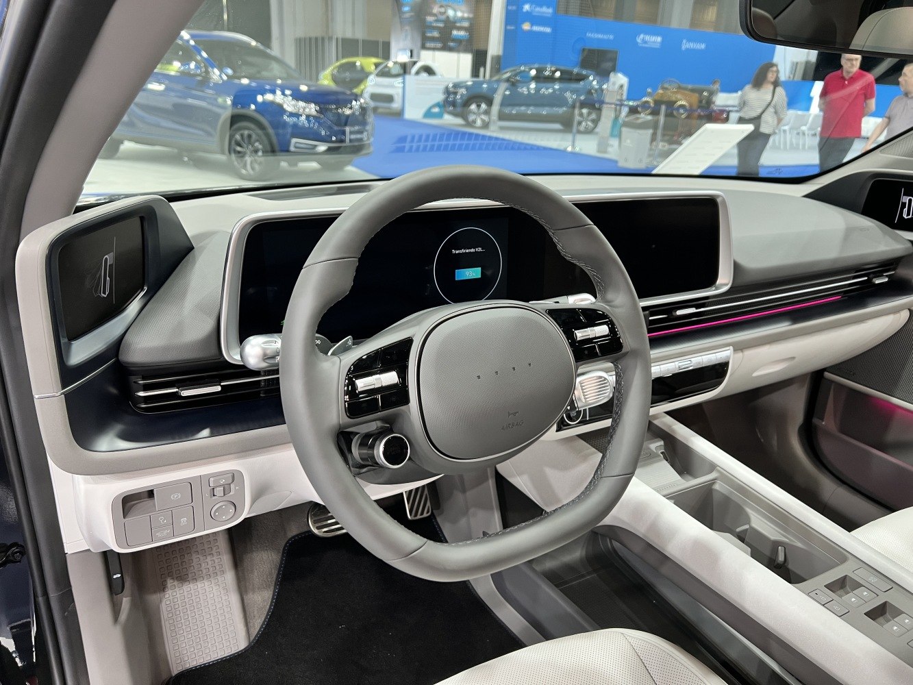 Modern steering wheel and digital dual-screen dashboard in car interior