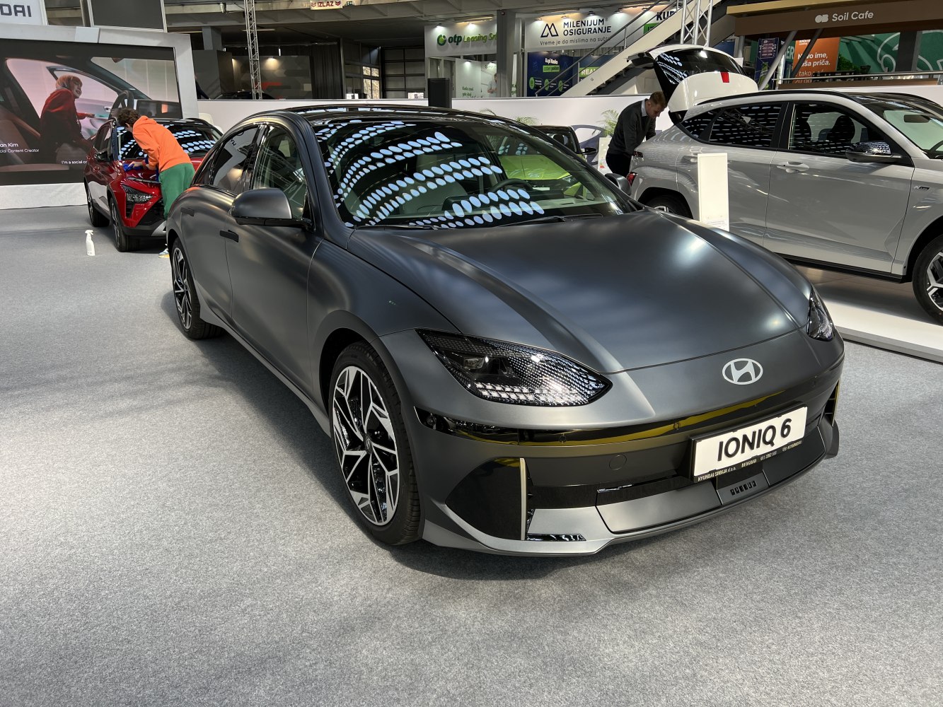Front view of matte finish electric sedan with aerodynamic design and modern headlights
