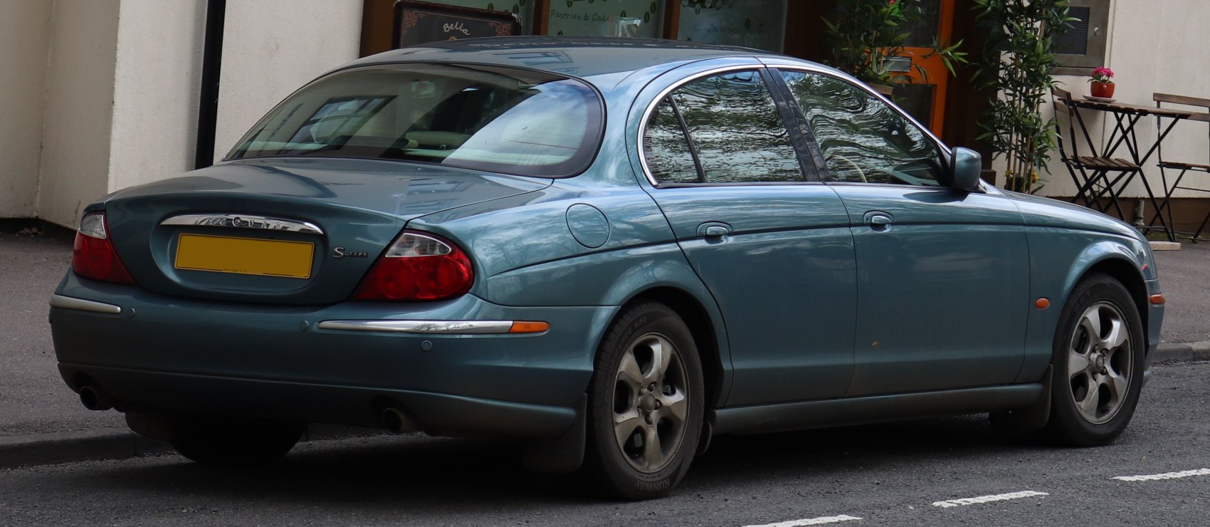 Rear and side view of a rounded tail light sedan