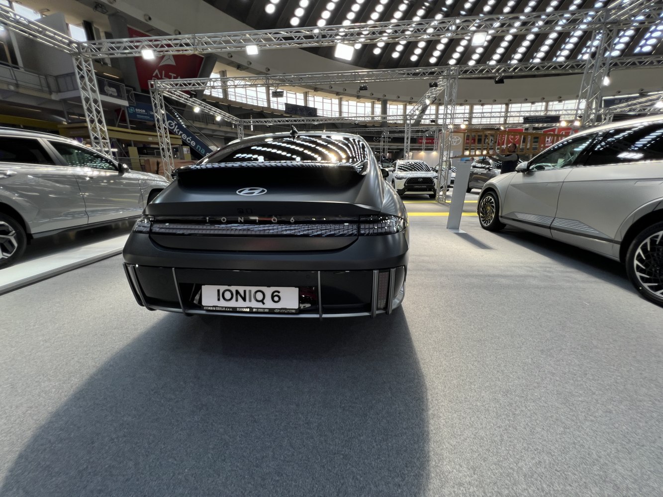 Rear view of sleek electric sedan with LED tail lights and aerodynamic design