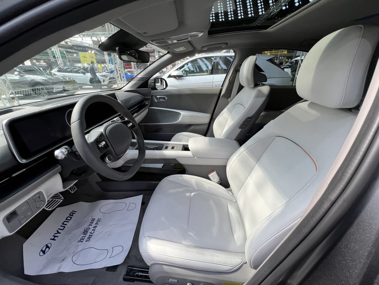 Modern dashboard and steering wheel with light-colored front seats