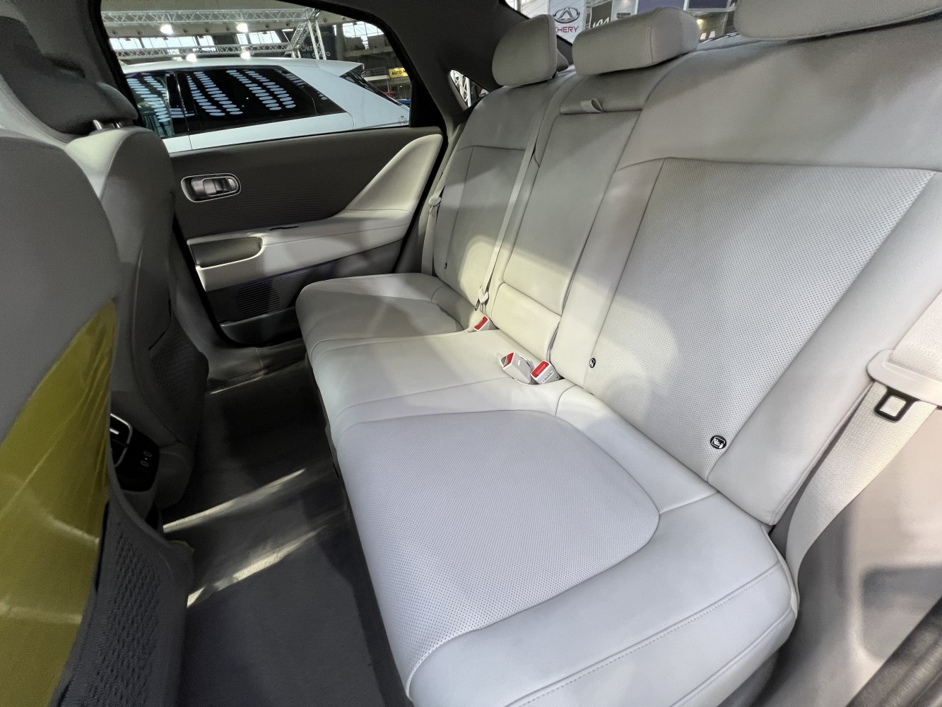Rear seat interior with light gray leather upholstery and ISOFIX anchors