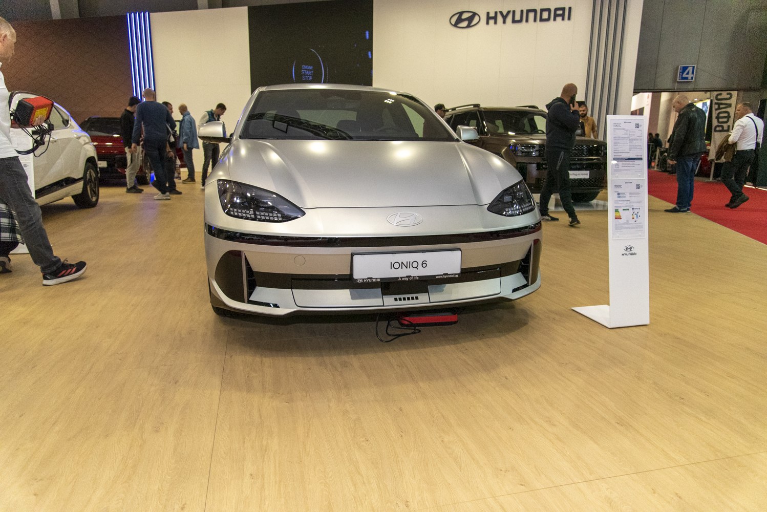 Front view of sleek electric sedan with distinctive headlights and aerodynamic design