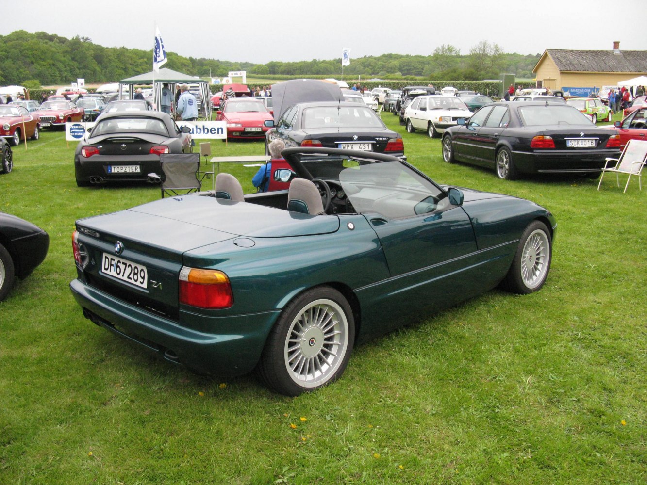 Convertible with hardtop cover and multi-spoke wheels