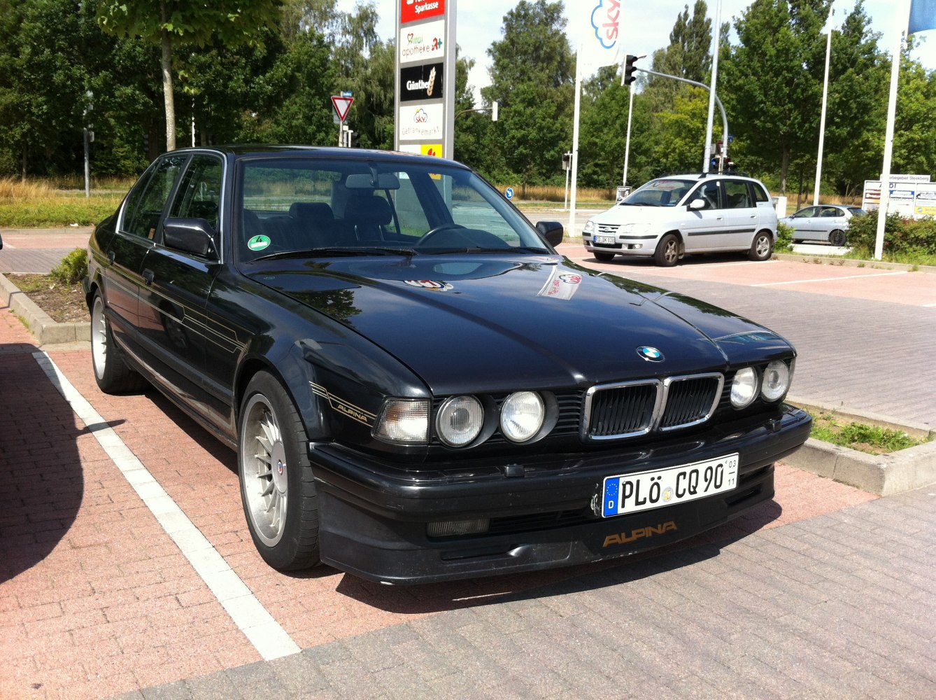 Front-side view with quad round headlights and Alpina signature alloy wheels