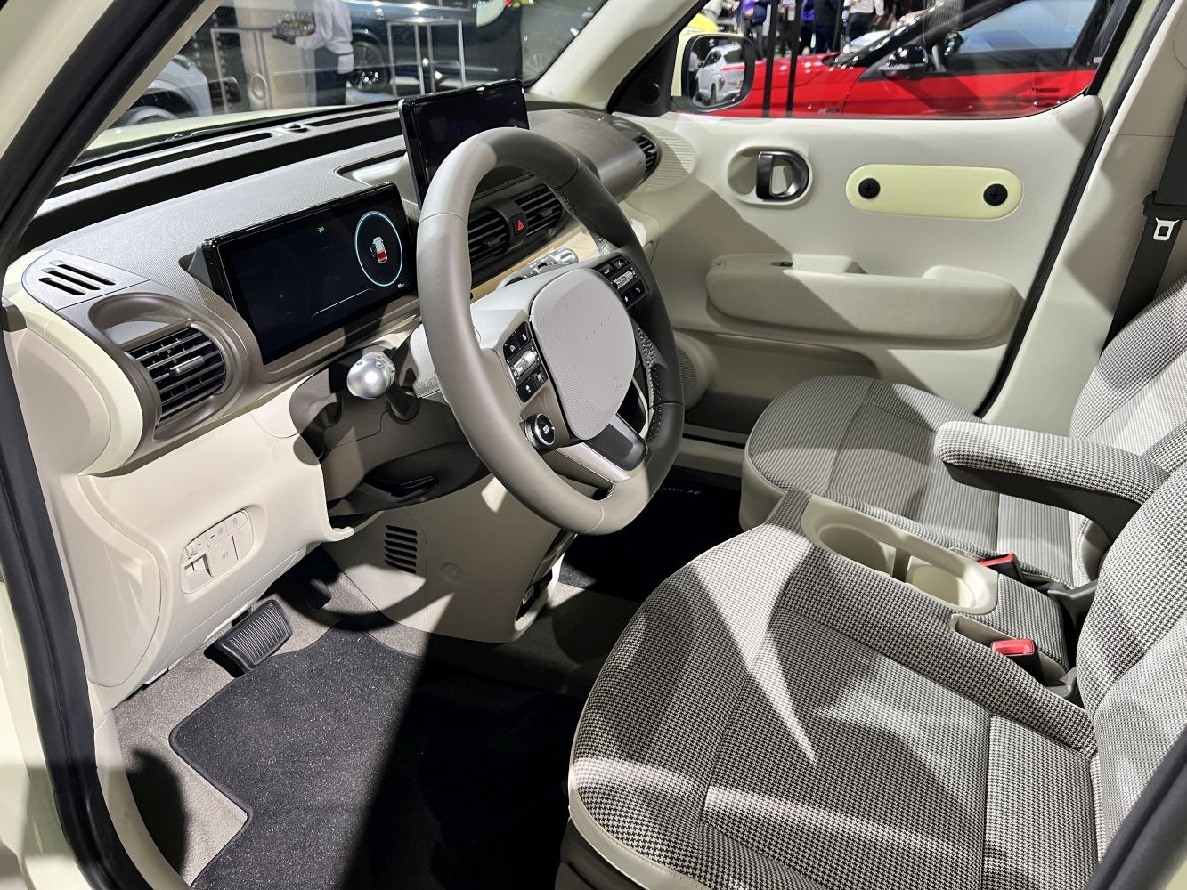 Modern dashboard and front seats with digital displays and fabric upholstery