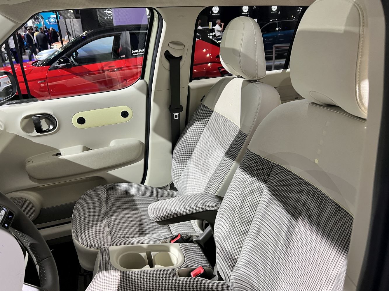Front seats and door panel with fabric upholstery and armrest
