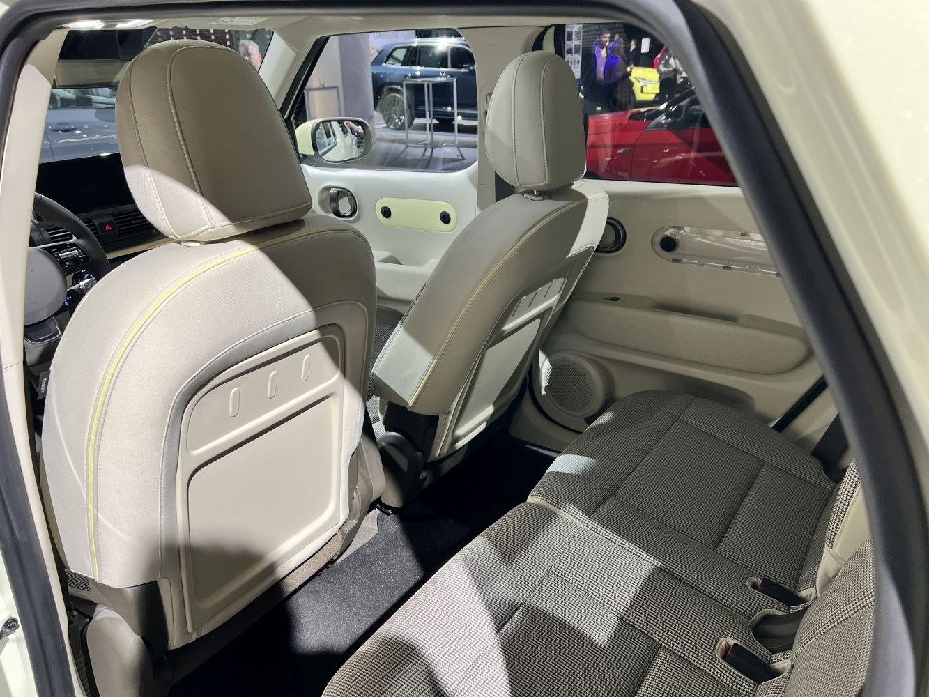 Rear seating and door panel design with fabric upholstery and integrated speakers