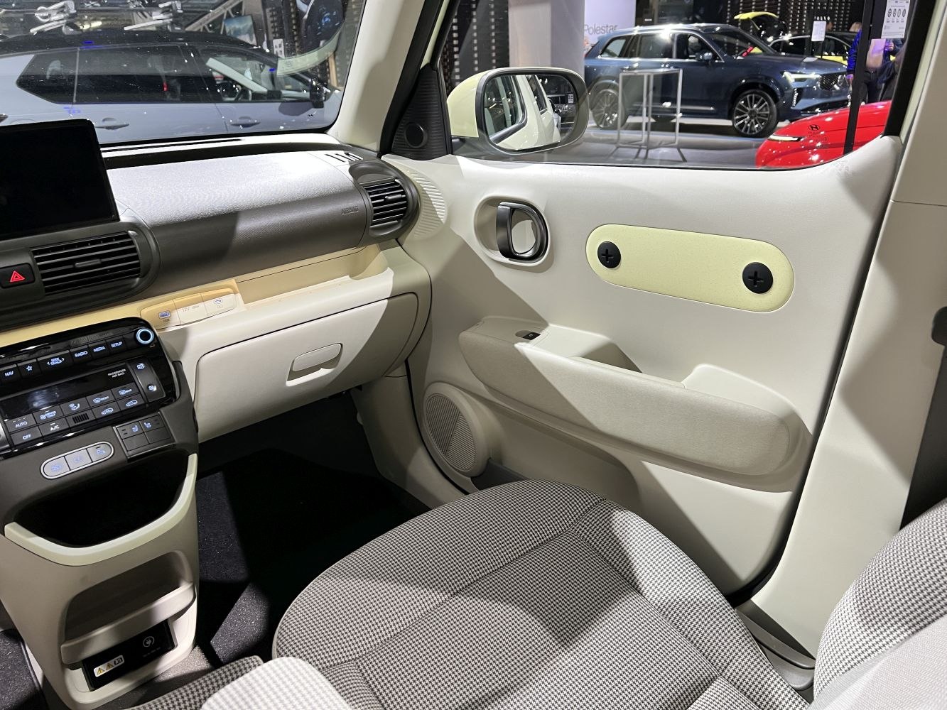 Minimalist car interior with dashboard and door panel in light beige tones