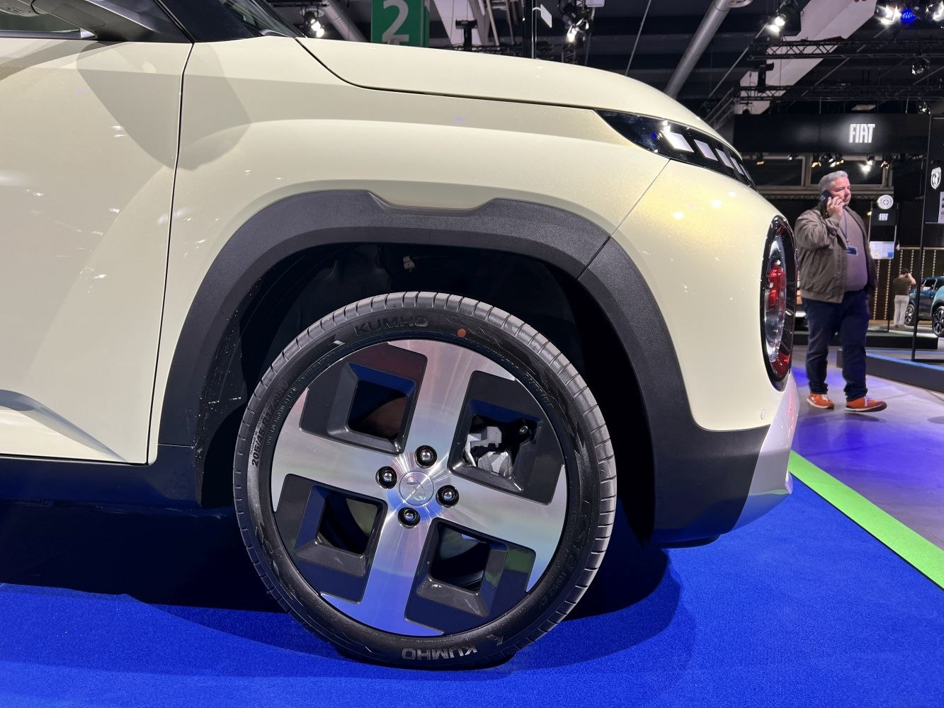 Front wheel and headlight design with alloy rim and tire close-up