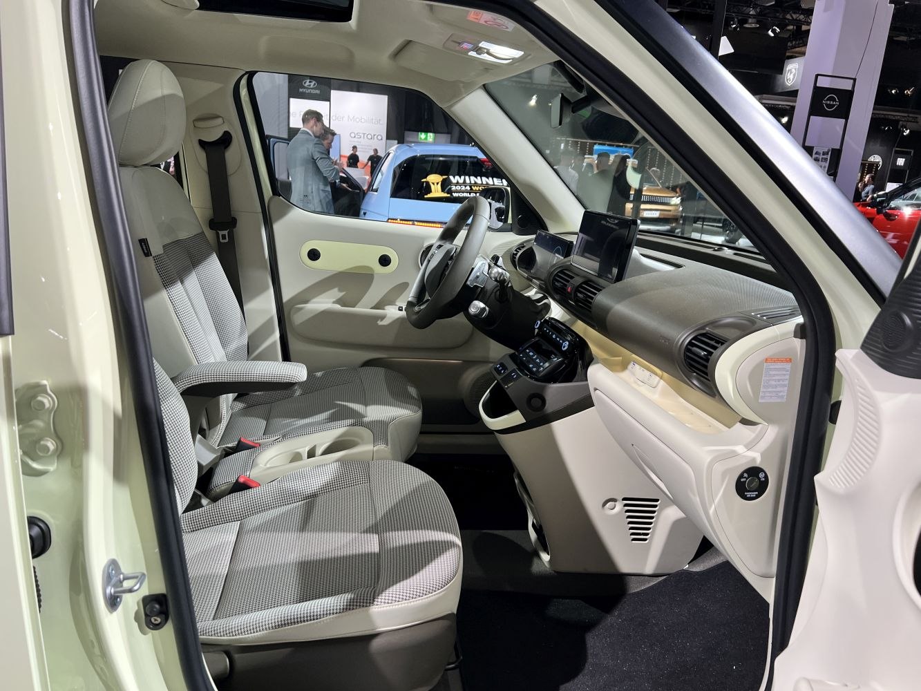 Modern vehicle interior with fabric seats and digital dashboard features