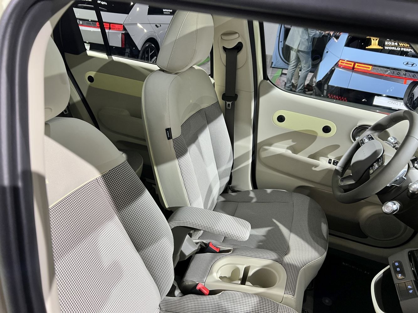 Modern car interior with fabric seats and steering wheel controls