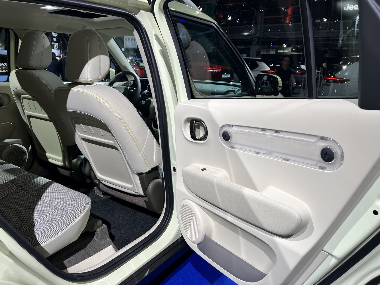 Rear passenger seats and open door interior with modern panel design