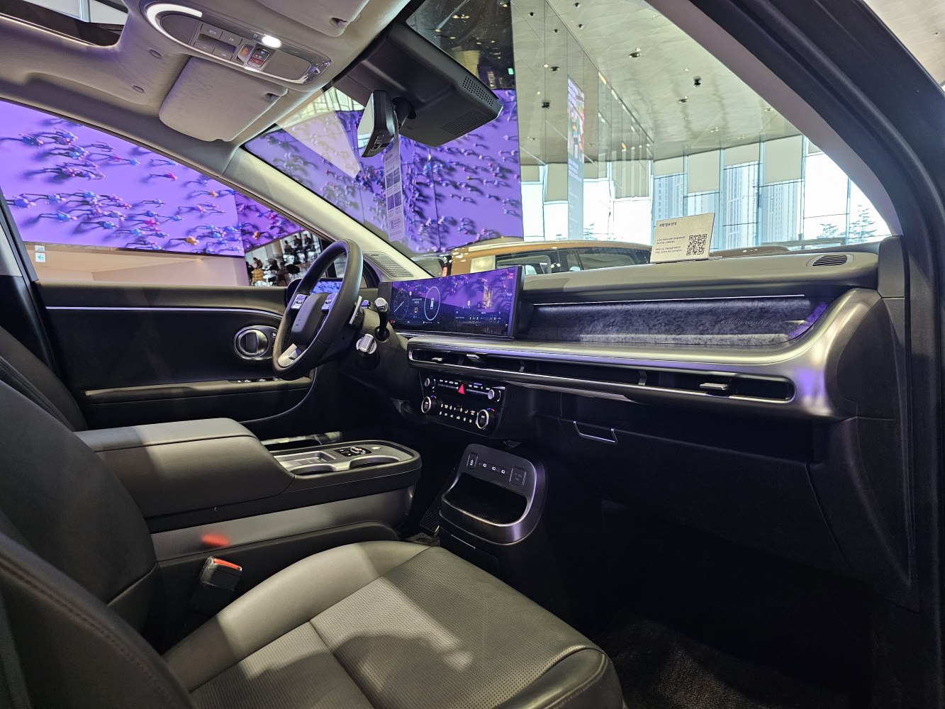 Wide digital dashboard and premium front seats with modern controls