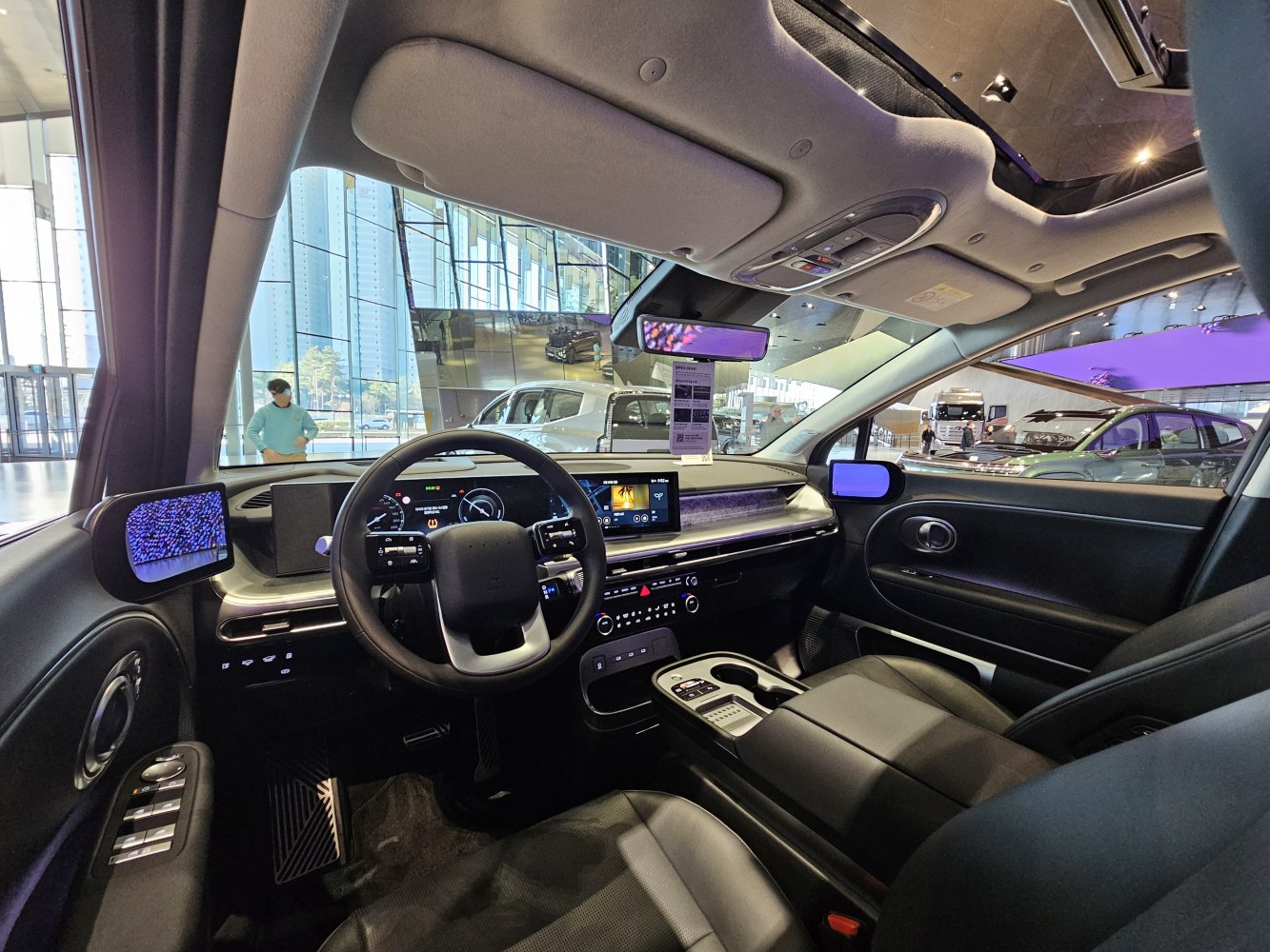 Modern electric SUV interior with digital side mirrors and advanced infotainment system