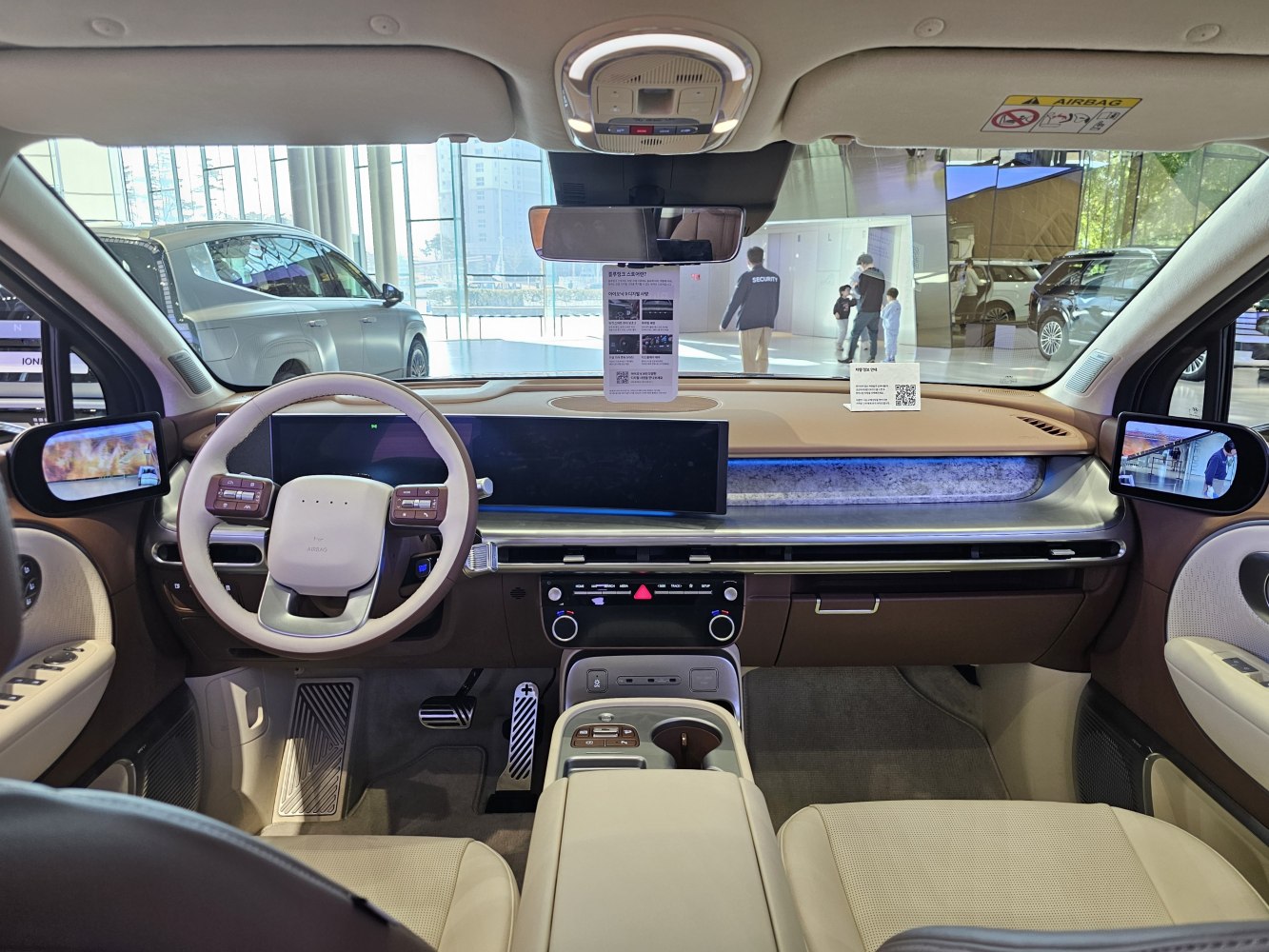 Car interior with digital side mirrors and wide infotainment screen