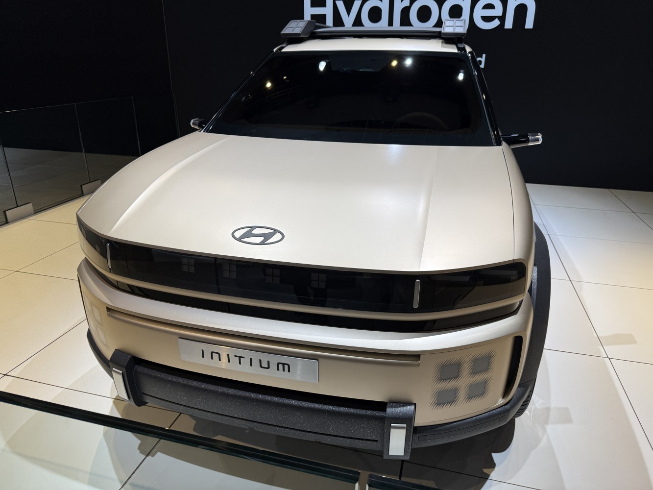 Distinctive horizontal LED headlight band and wide textured front bumper.