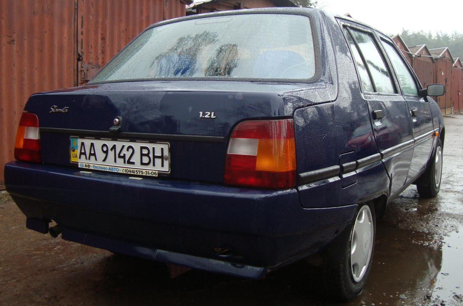 Rear view of compact sedan with 1.2L engine and rectangular taillights