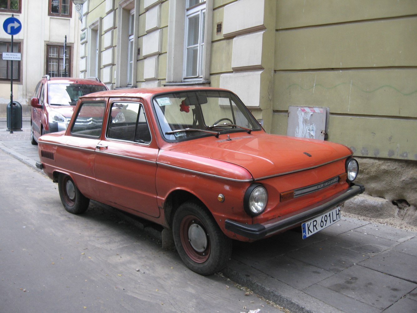 Vintage compact sedan with round headlights and simple design.
