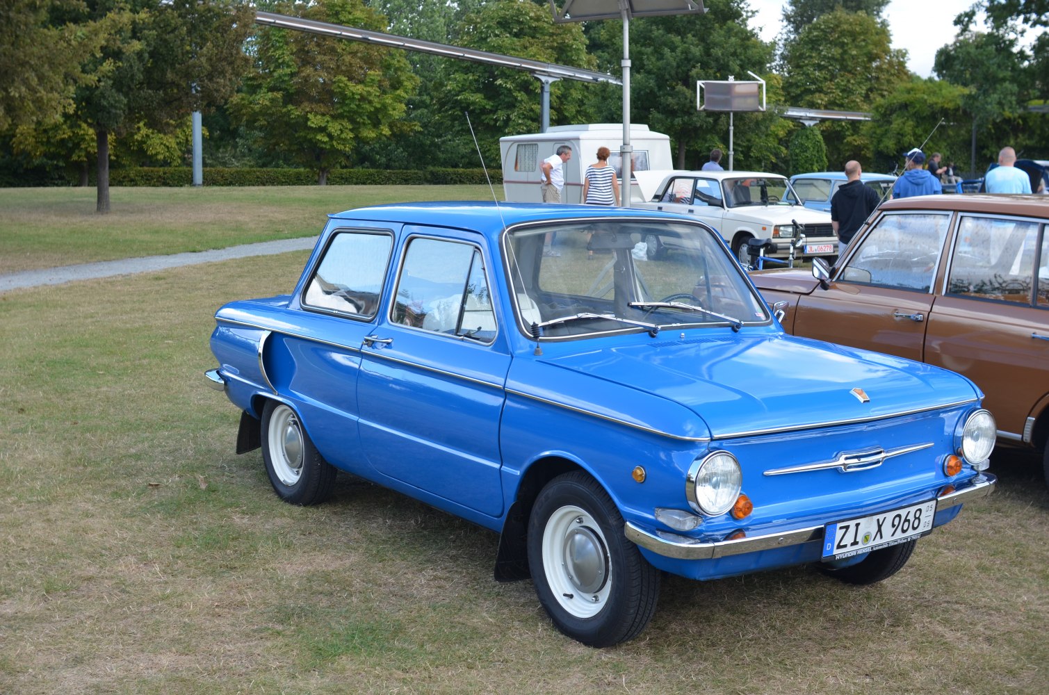 Vintage blue compact sedan with round headlights and chrome bumper