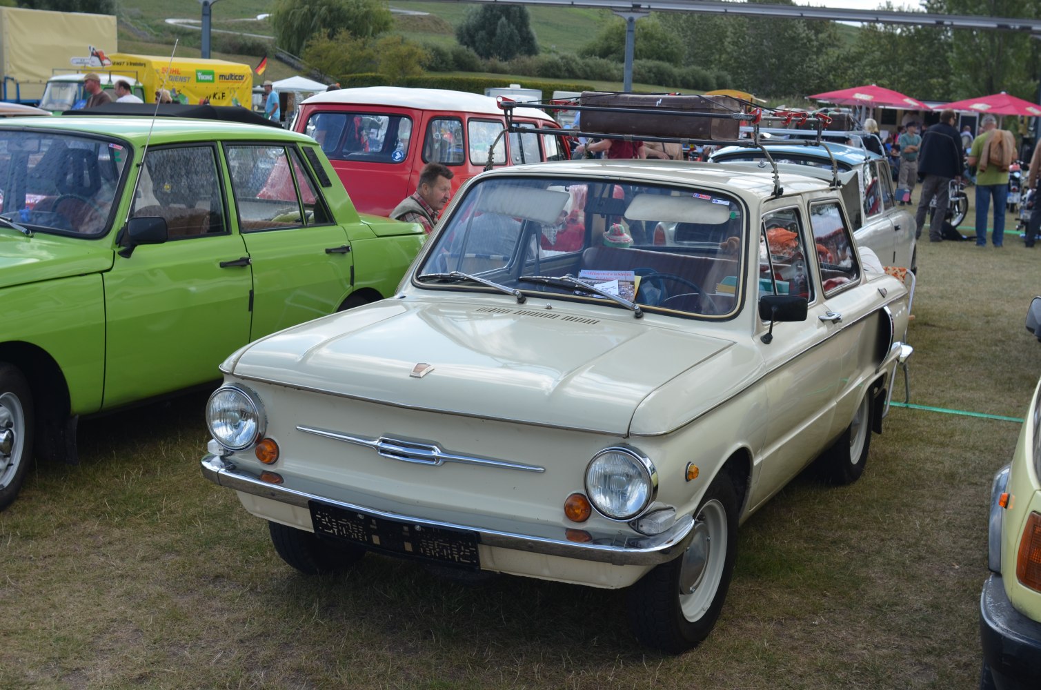 Compact sedan with round headlights and roof rack