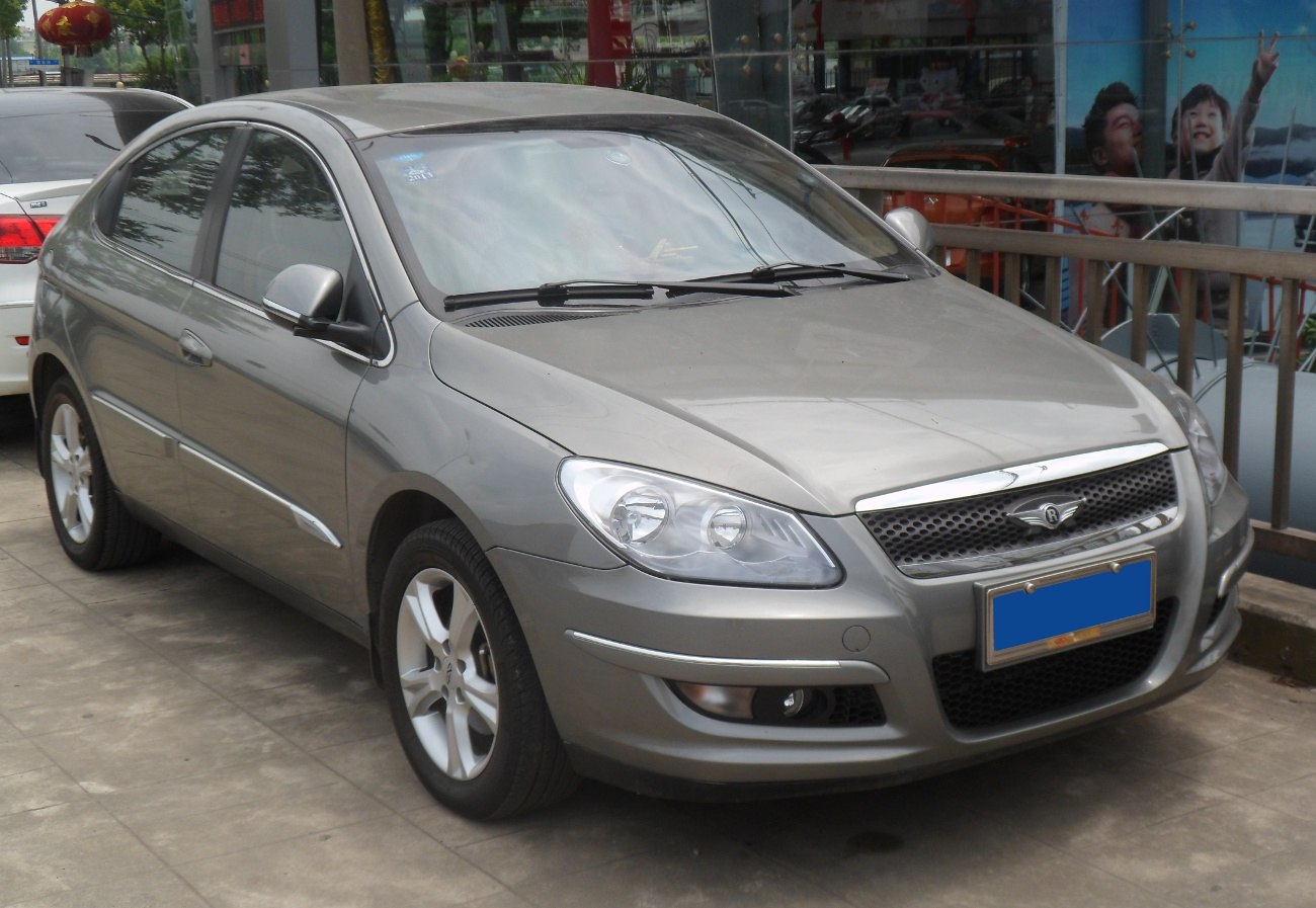 Compact sedan with sleek headlights and chrome-accented grille