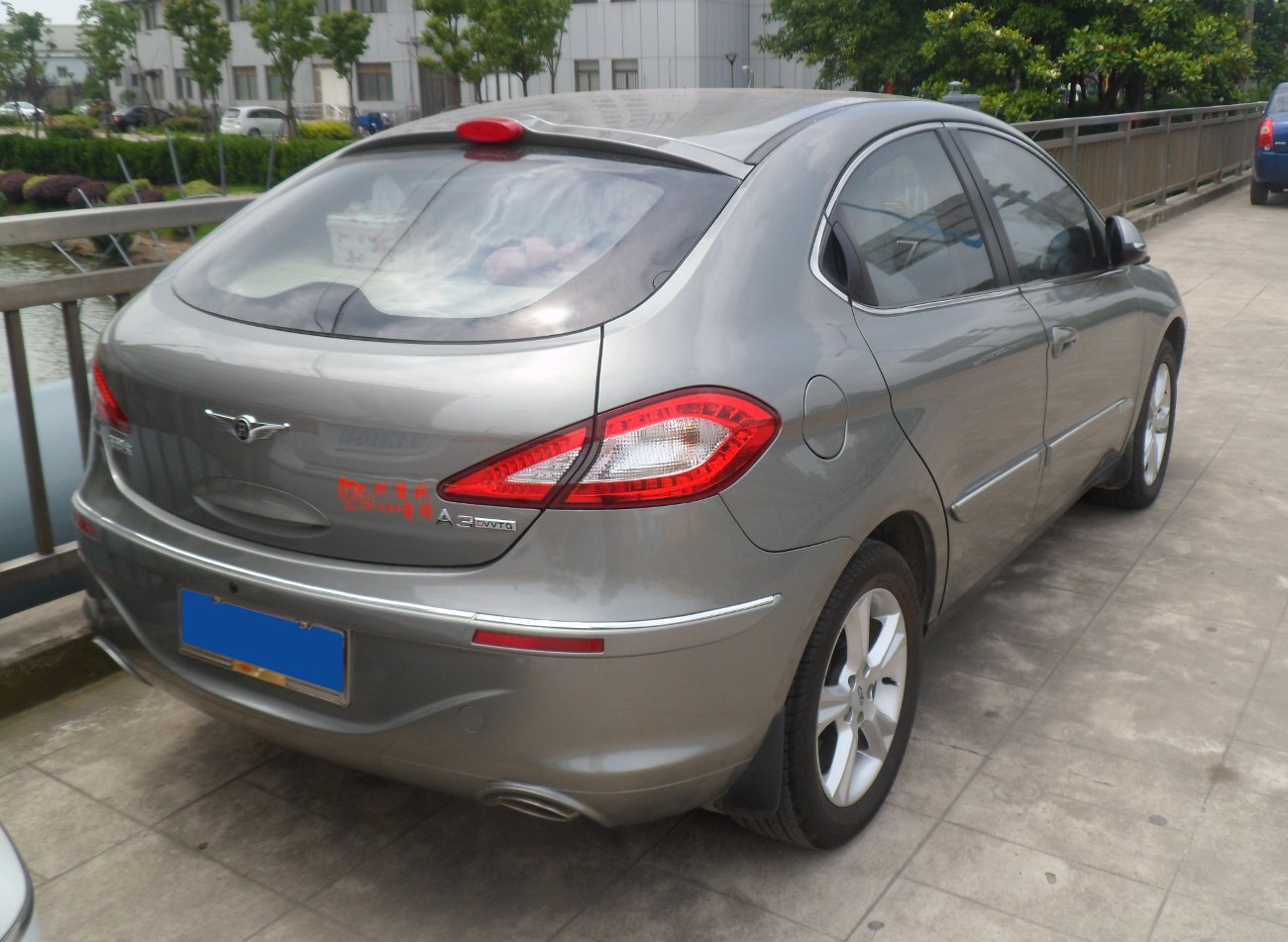 Rear side view of gray hatchback showing distinct taillights and alloy wheels