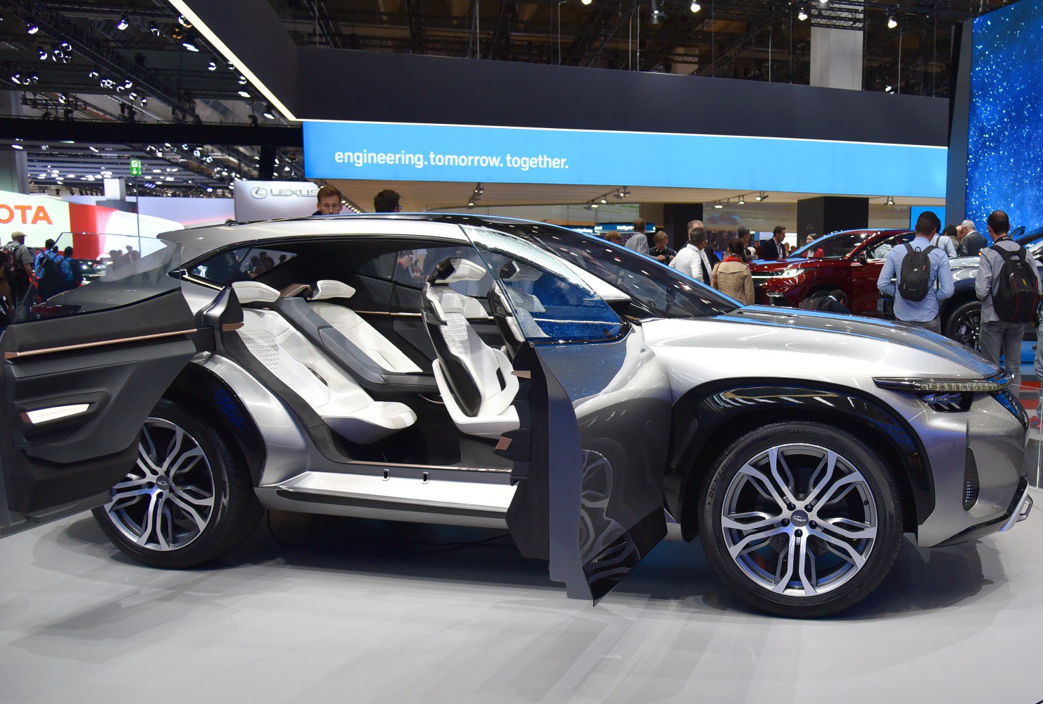 Futuristic SUV with split-opening doors and white interior seats