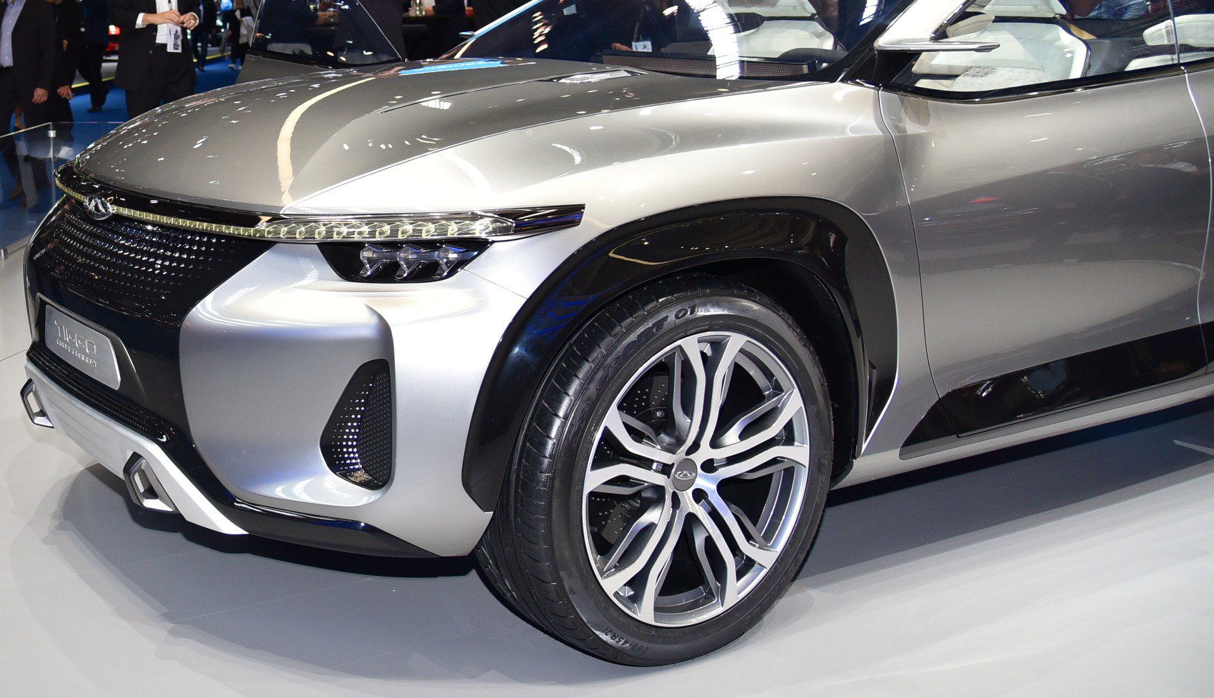 Close-up of futuristic SUV front fascia and alloy wheel