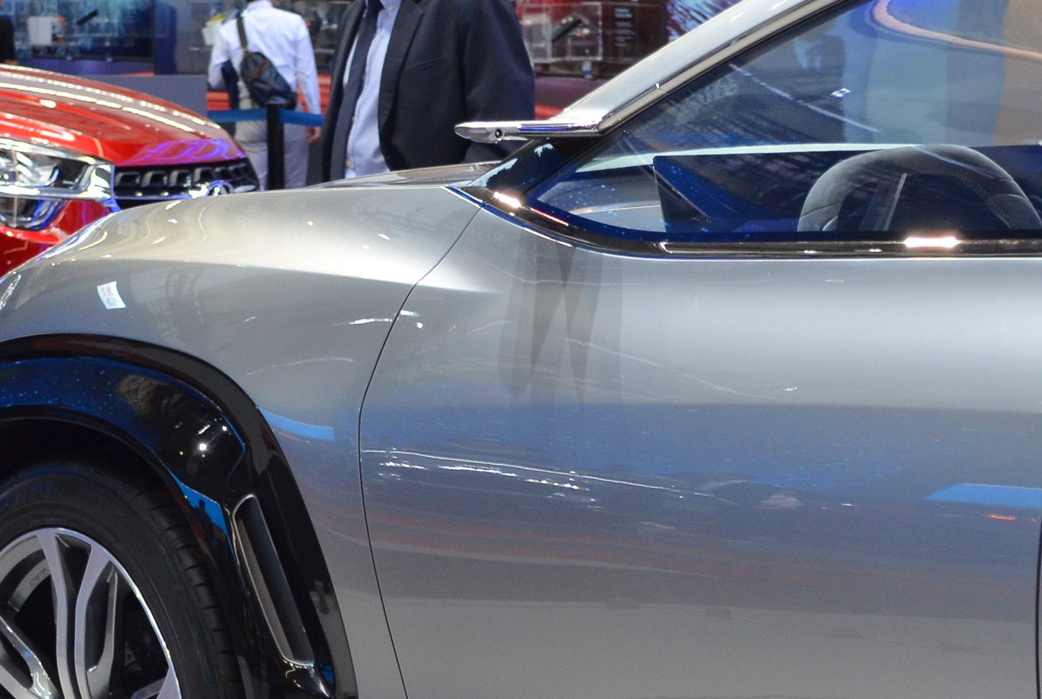 Sleek sport coupe profile with distinctive side mirror