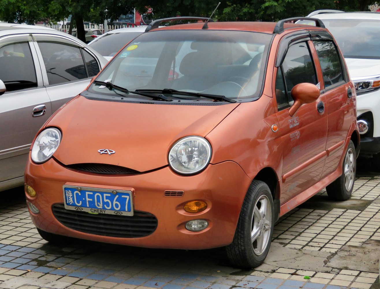 Compact hatchback with round headlights and roof rails