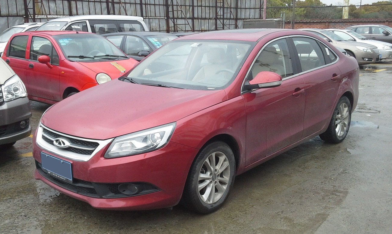 Front-side view of mid-size sedan with distinct headlights and modern grille.