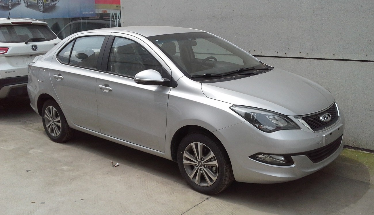 Silver four-door compact sedan with alloy wheels and sleek headlights