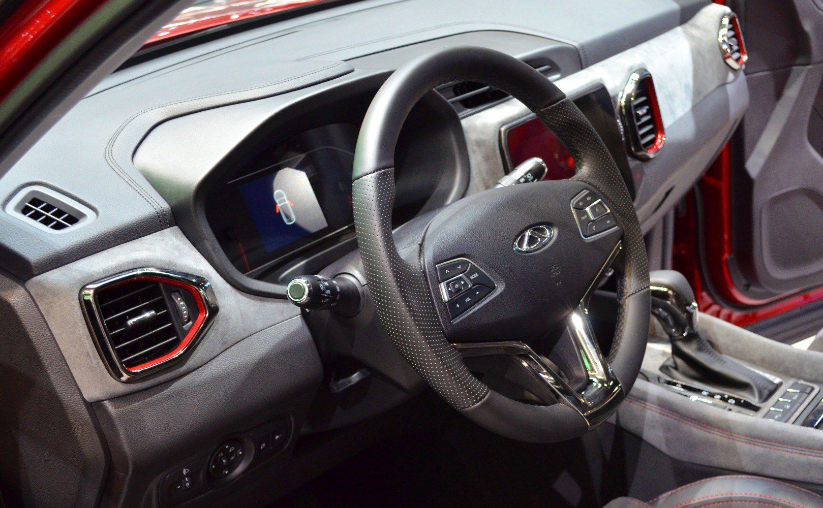 Multifunction steering wheel and digital dashboard with air vents.