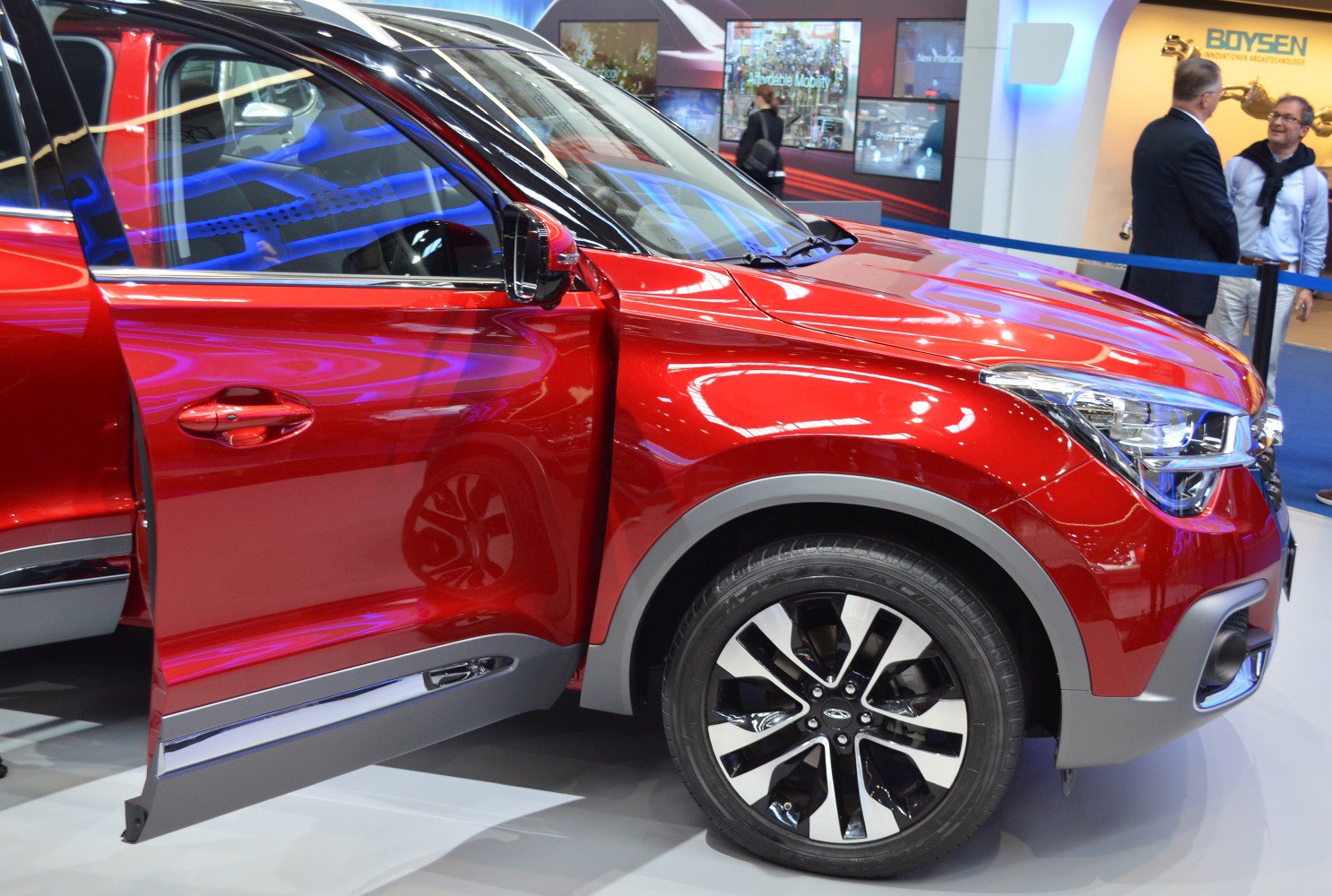 Red SUV front side with open door and alloy wheel